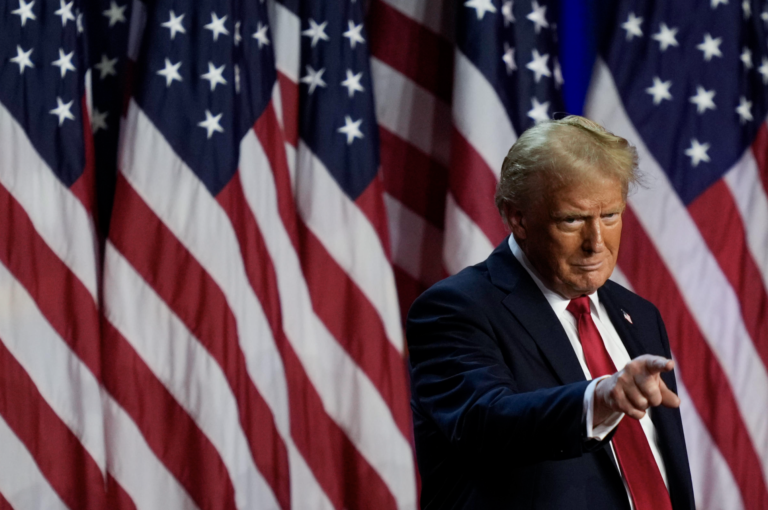 Donald Trump points to the crowd at an election night watch party. (Julia Demaree Nikhinson/AP)